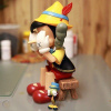 Kaws Pinocchio & Jiminy Cricket Фігурка Піноккіо Сидячий (Дісней) - 22 см